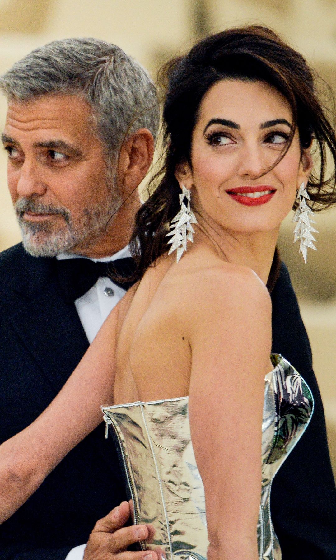 George Clooney and lawyer Amal Clooney enter the Heavenly Bodies: Fashion & The Catholic Imagination Costume Institute Gala at The Metropolitan Museum on May 07, 2018 in New York City.  (Photo by Ray Tamarra/GC Images)
