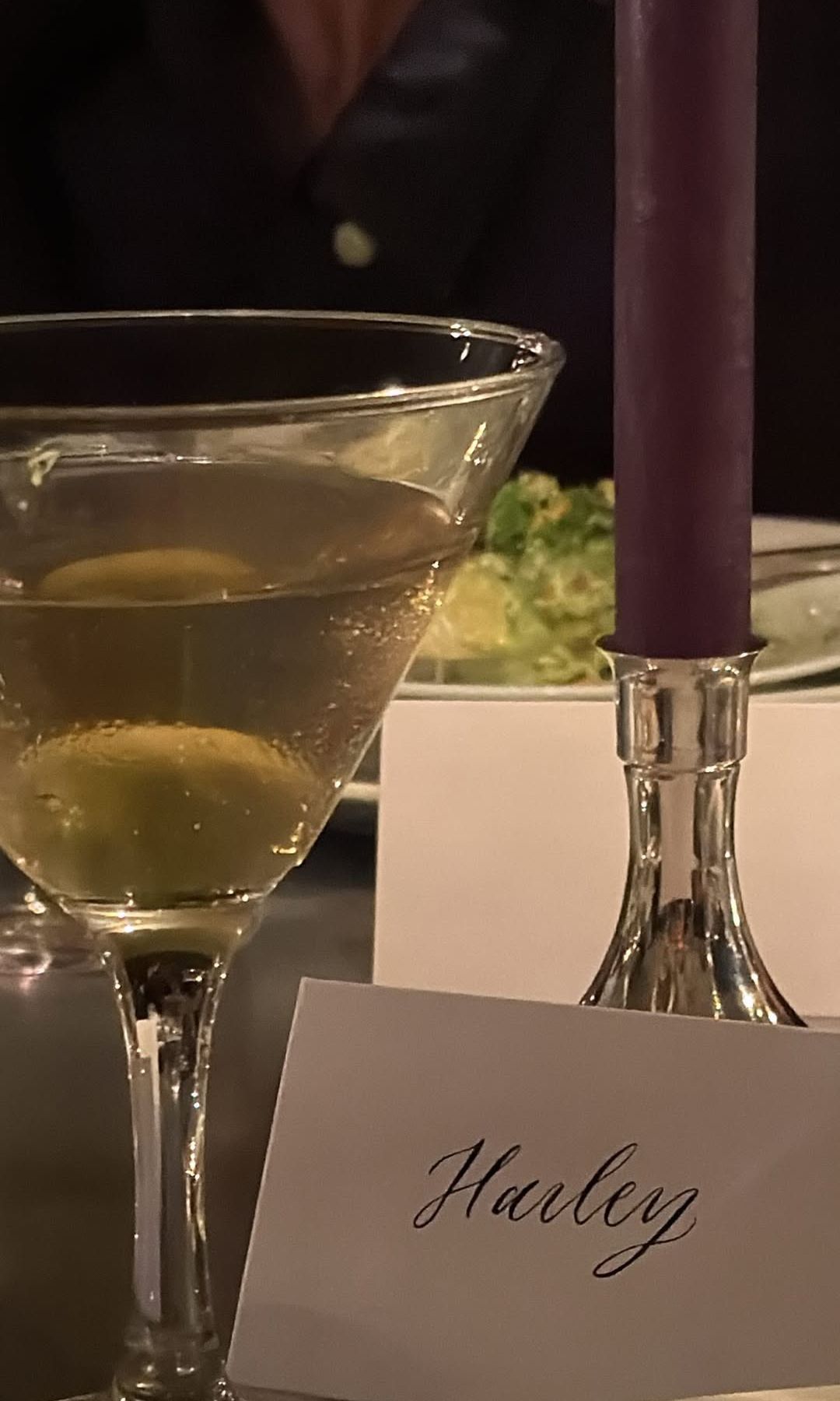 Hailey Bieber shares a picture of a martini, candle and place card at a dinner