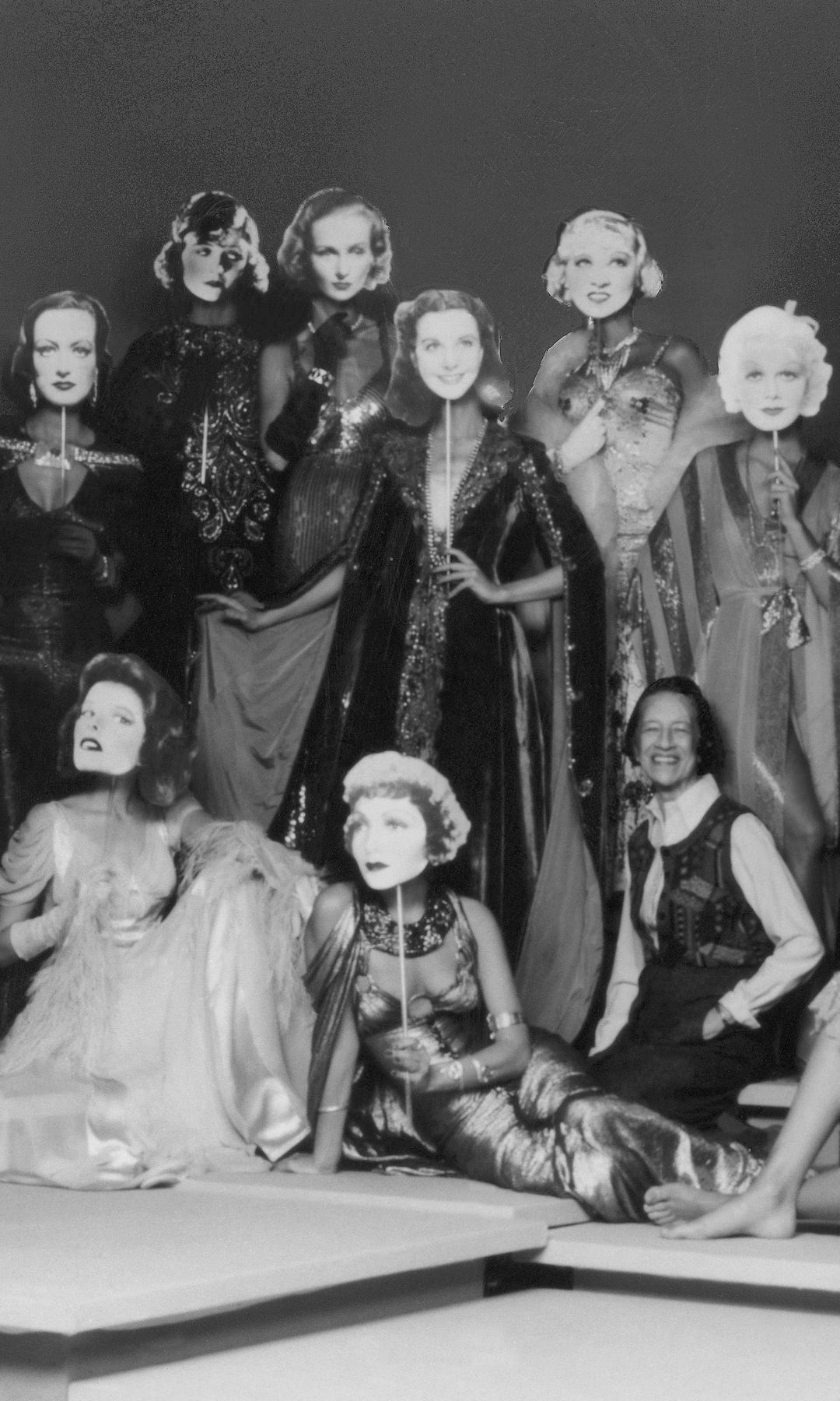 Diana Vreeland sits center among women in glamorous gowns and Hollywood starlet face masks for the 1974 Met Gala exhibition "Romantic and Glamorous Hollywood Design" at the Met Museum.