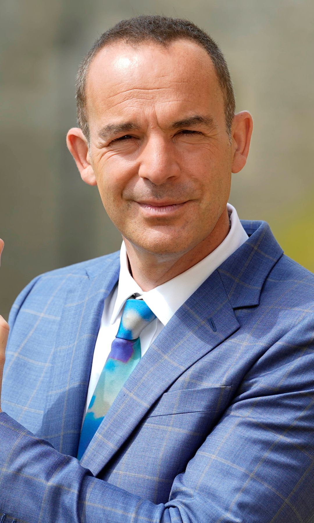 Martin Lewis holding up his CBE