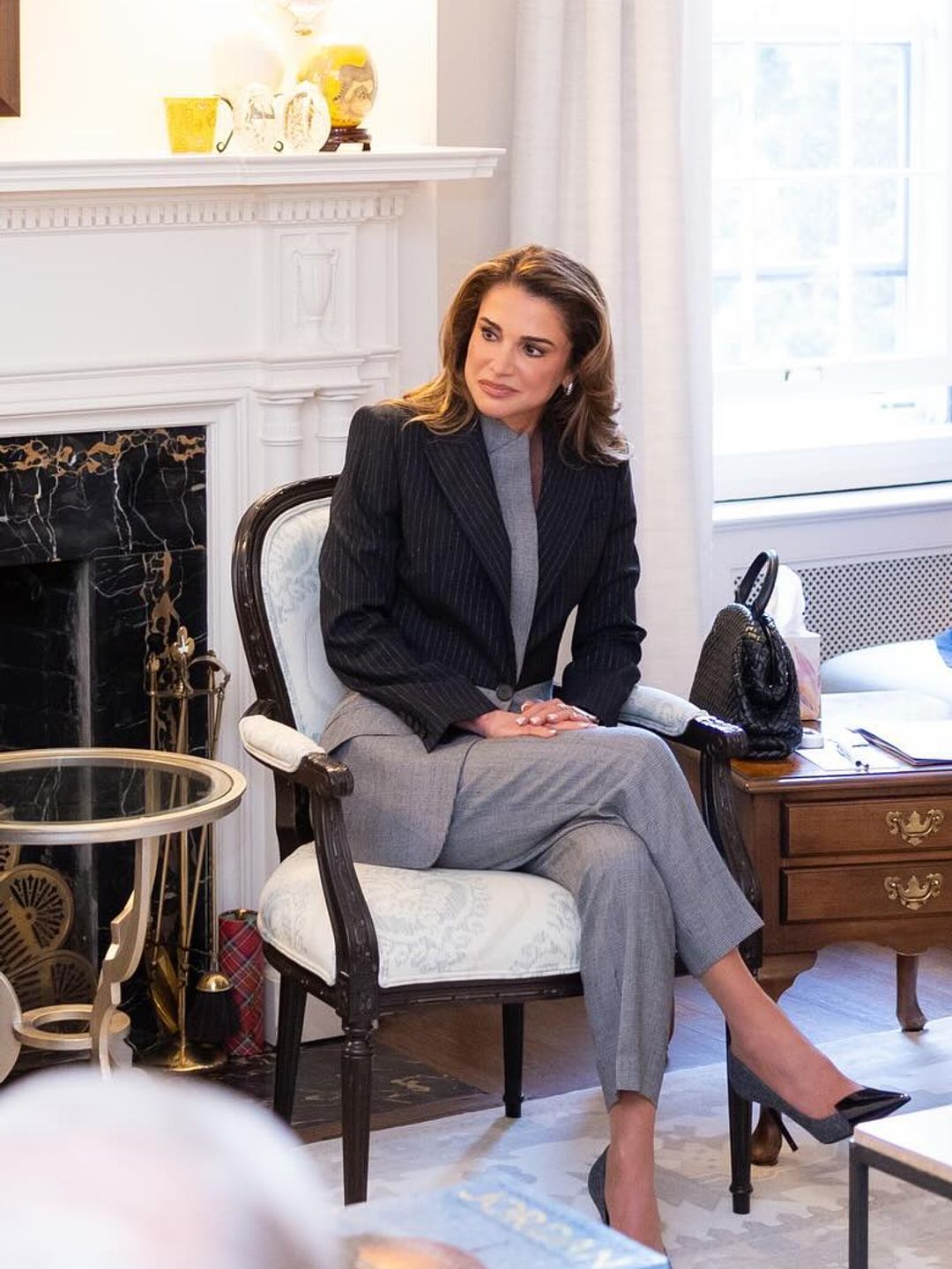 Queen Rania wears an Alexander McQueen suit to sit in on a business meeting in the USA