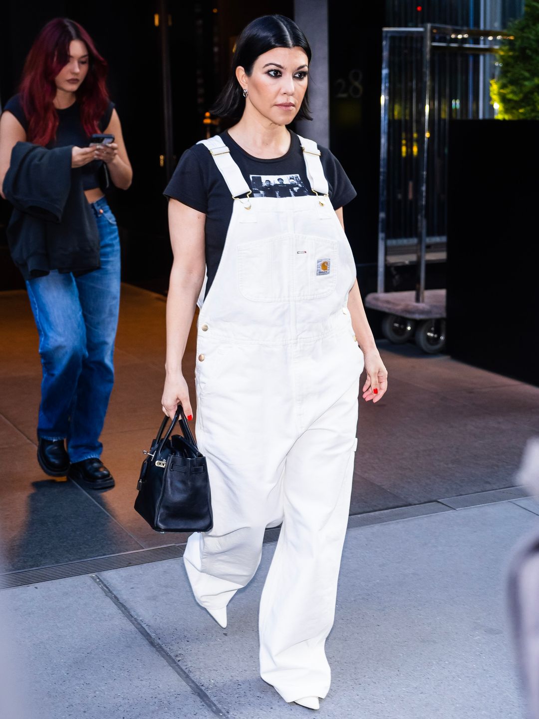 Kourtney Kardashian wearing white dungarees 