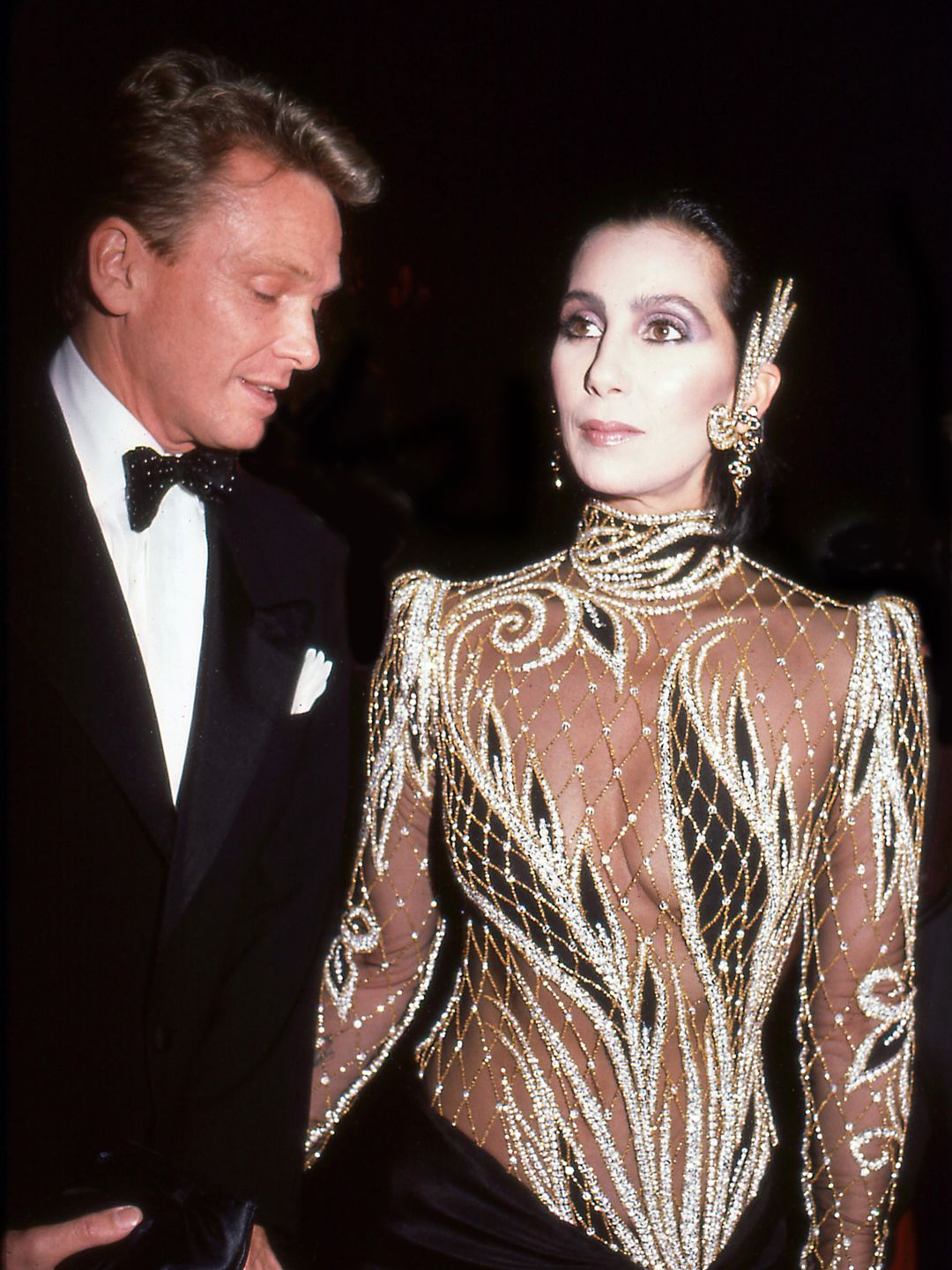 Designer Bob Mackie and Cher attending the 1985 Met Gala 