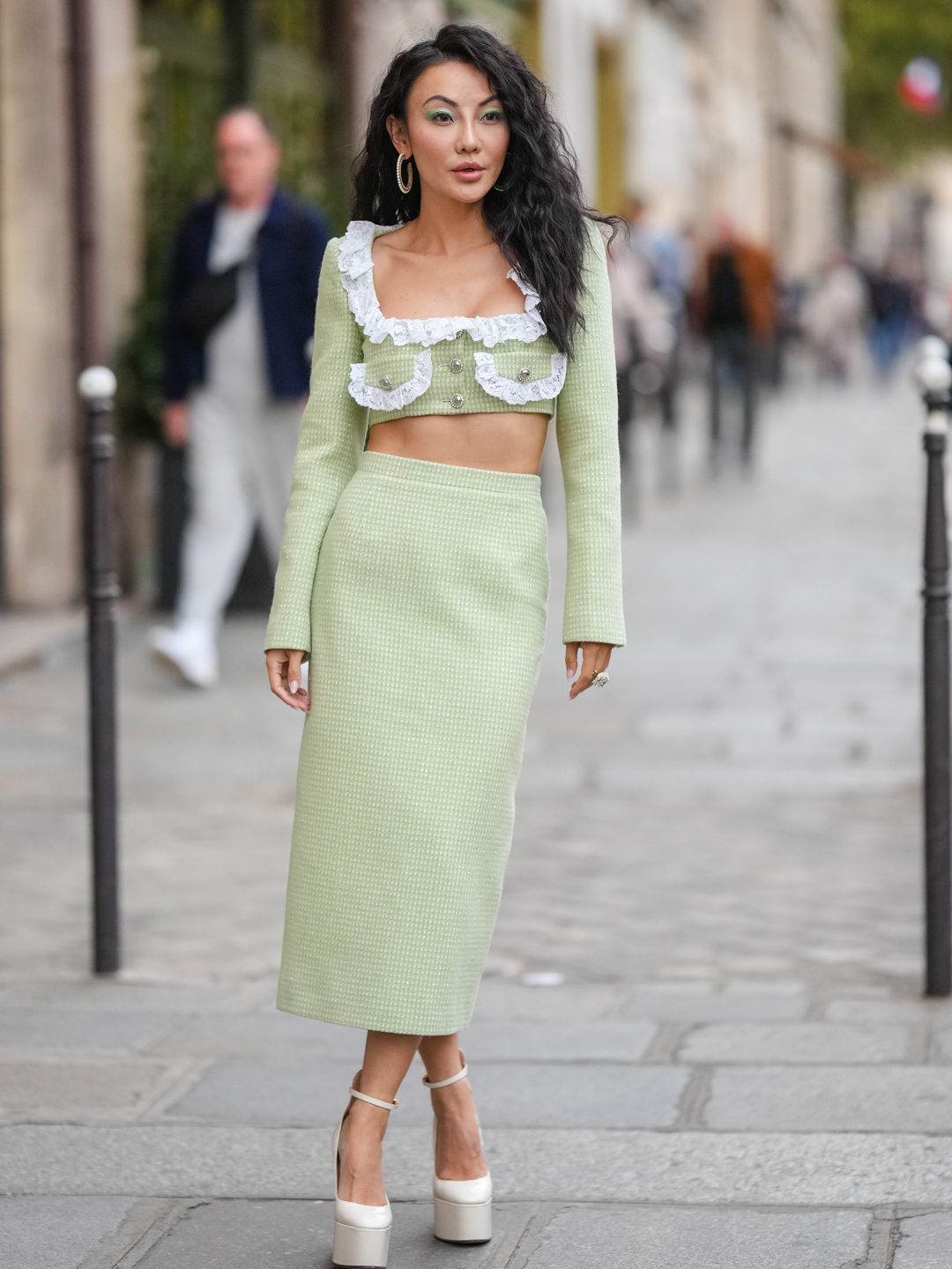 Jessica Wang wearing a pale green frill crop top and midi skirt 