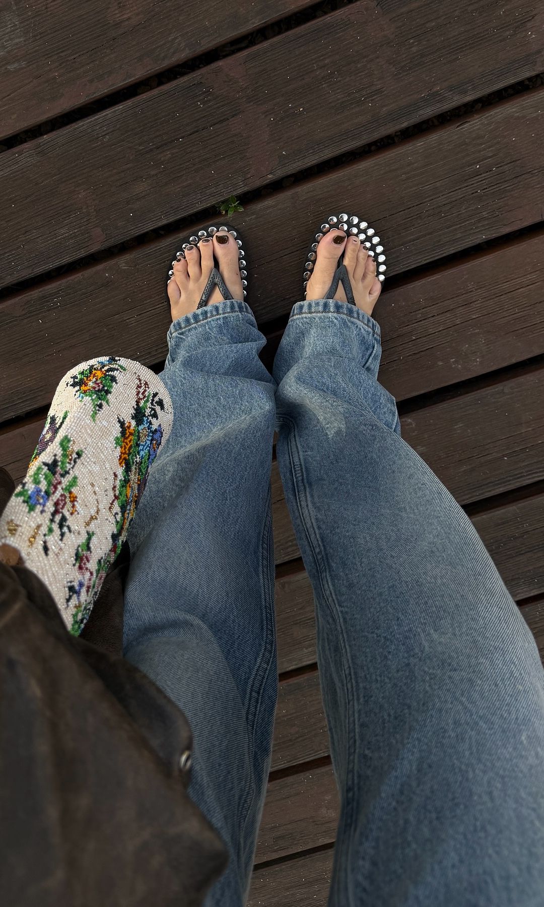 An influencer takes a picture of her black flip flops 