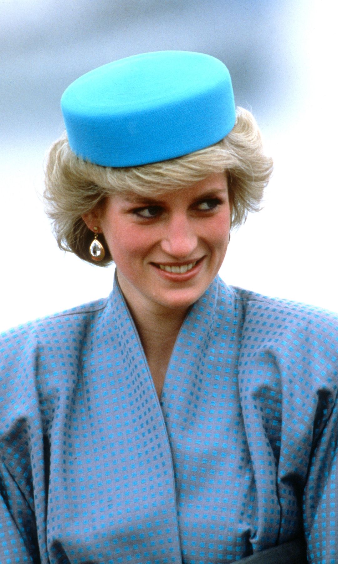 Diana, Princess of Wales, wearing a blue pillbox hat designed by milliner Gina Foster, smiles as she attends a reception at Swy-A-Lane Park on May 1, 1986 in Nanaimo, Canada