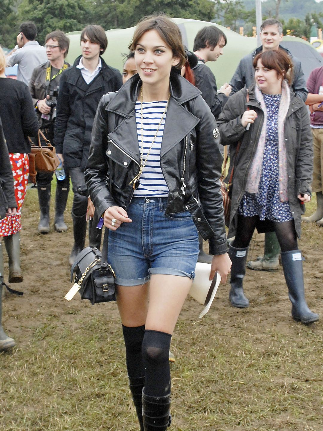 Alexa Chung  attends Glastonbury Festival in 2008 wearing a stripe shirt, leather jacket, denim mini shorts and over-the-knee socks