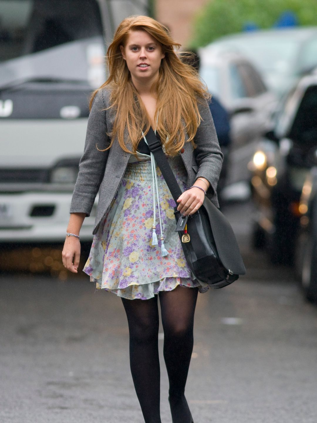 Princess Eugenie walking in a floral mini dress, tights and grey cardigan