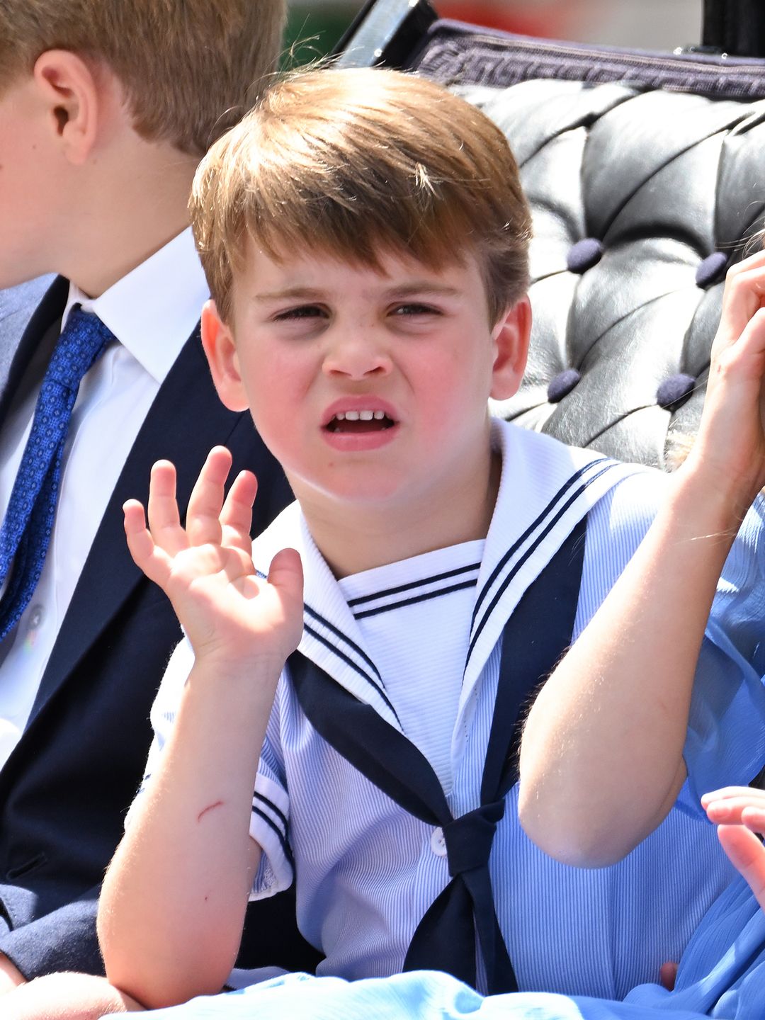 Prince Louis waving while dressed in a sailor's outfit