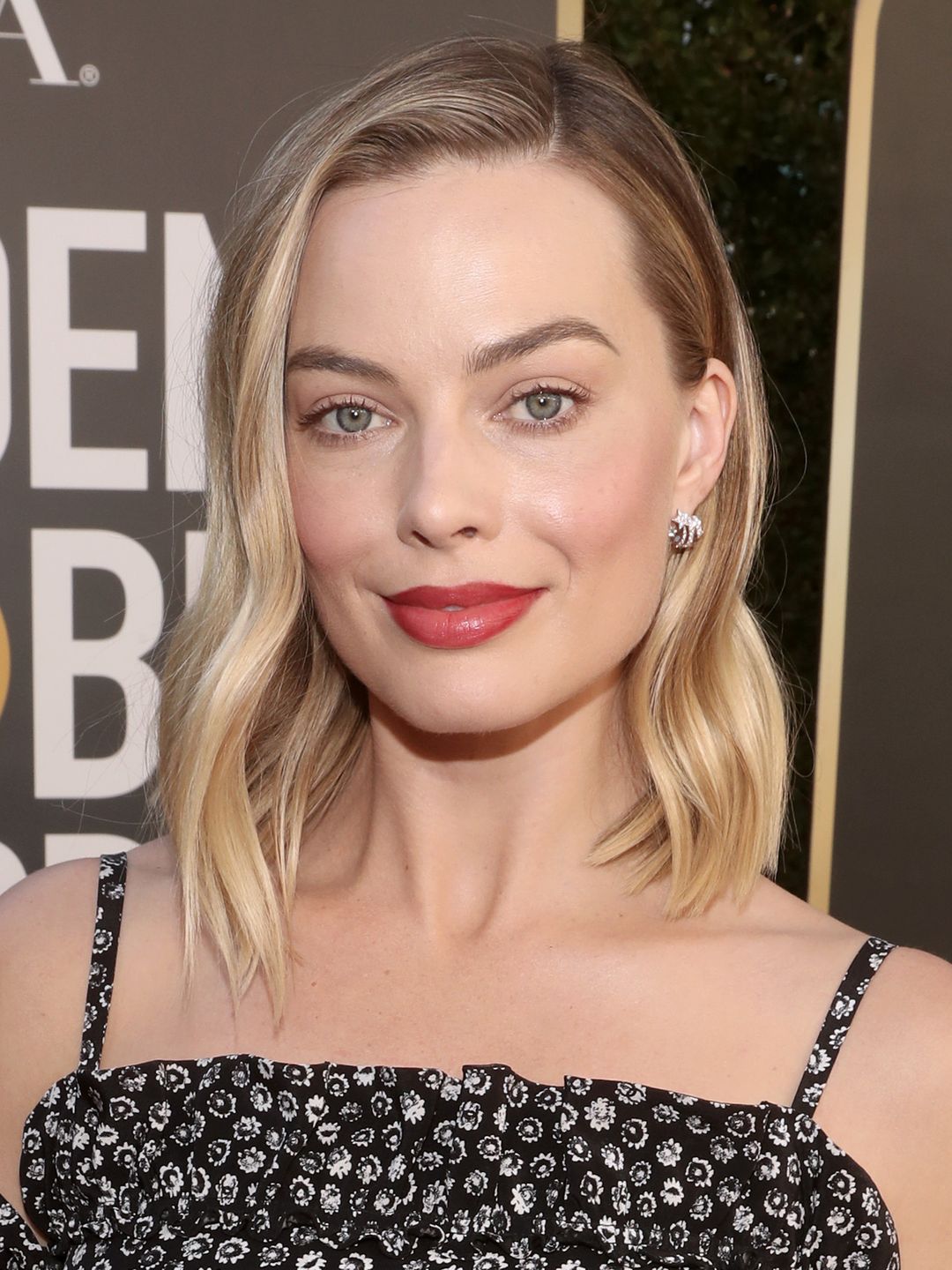Margot Robbie sports a side parting with loose waves 
