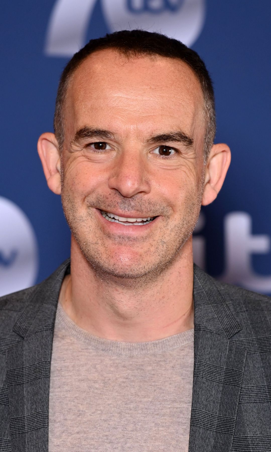 Martin Lewis smiling in a suit