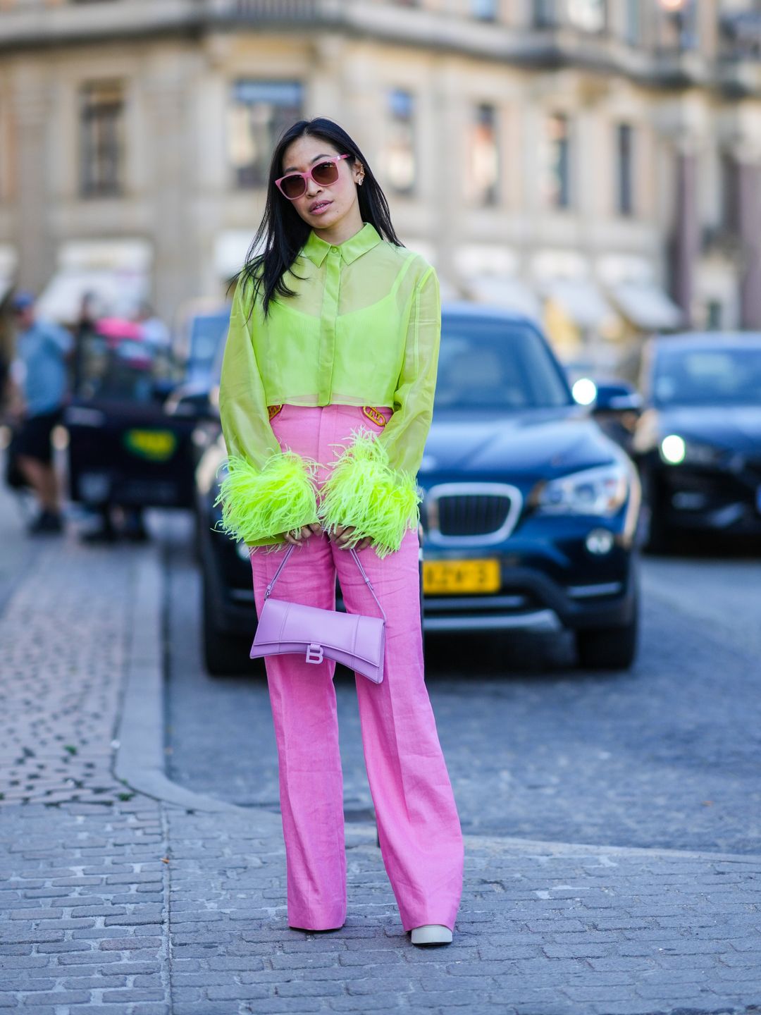 Miki Cheung wears an acid green cropped shirt and pink high-waisted trousers 