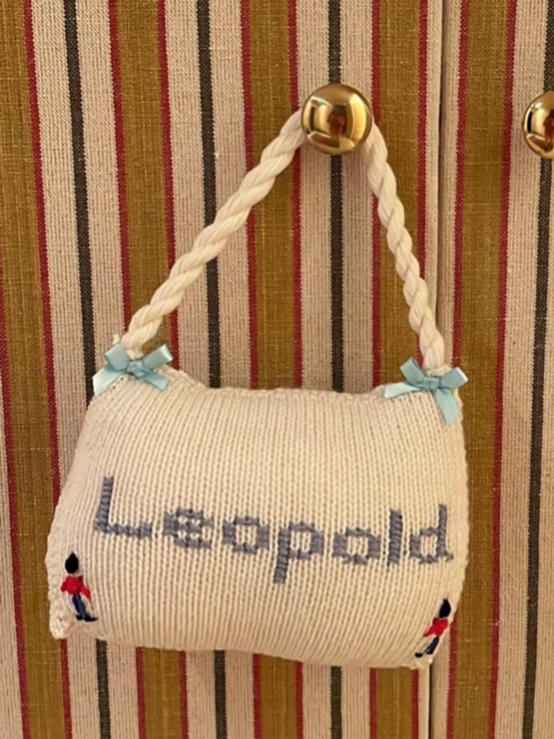 A knitted bag with the word Leopold