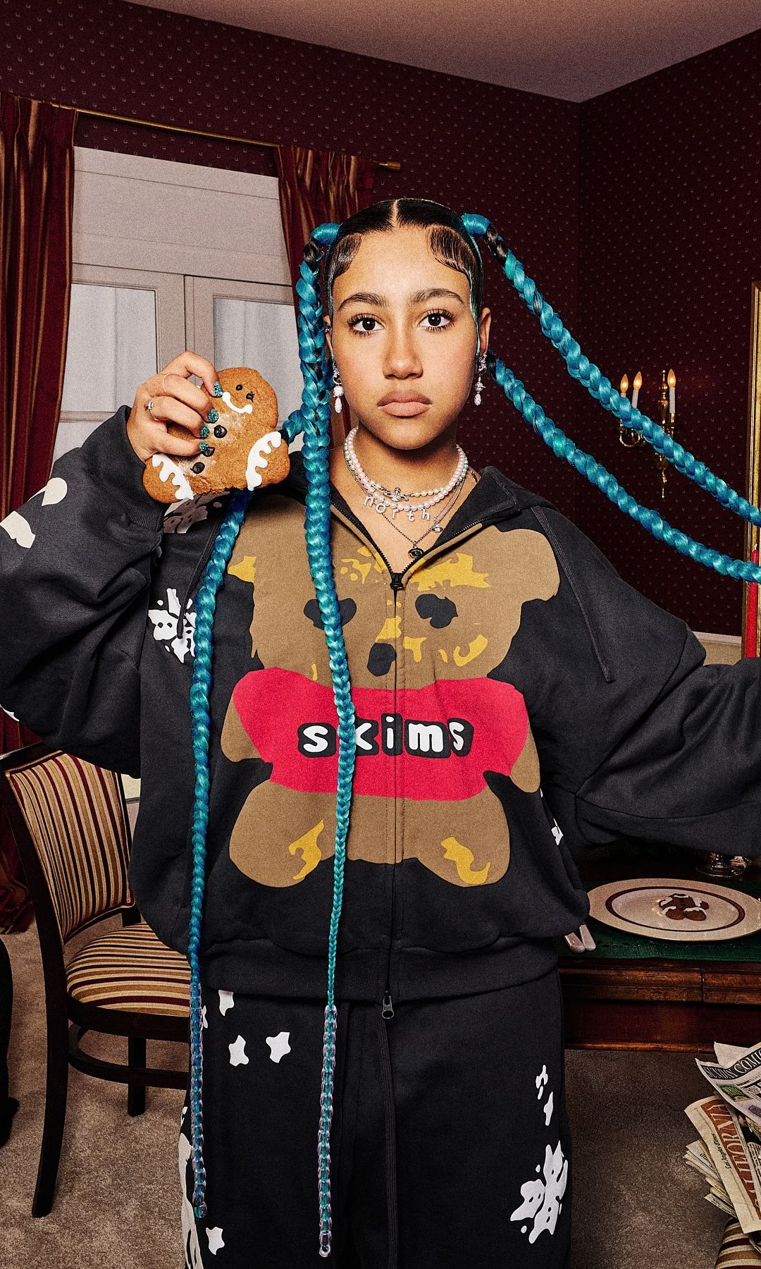 North West poses for the new Skims collection in a printed black tracksuit 