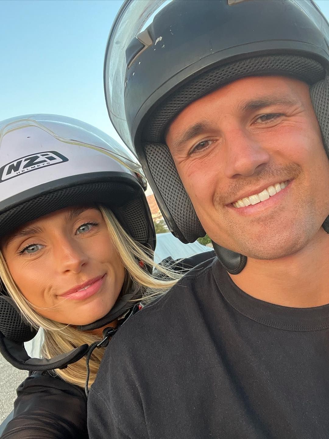 couple posing for picture on moped 