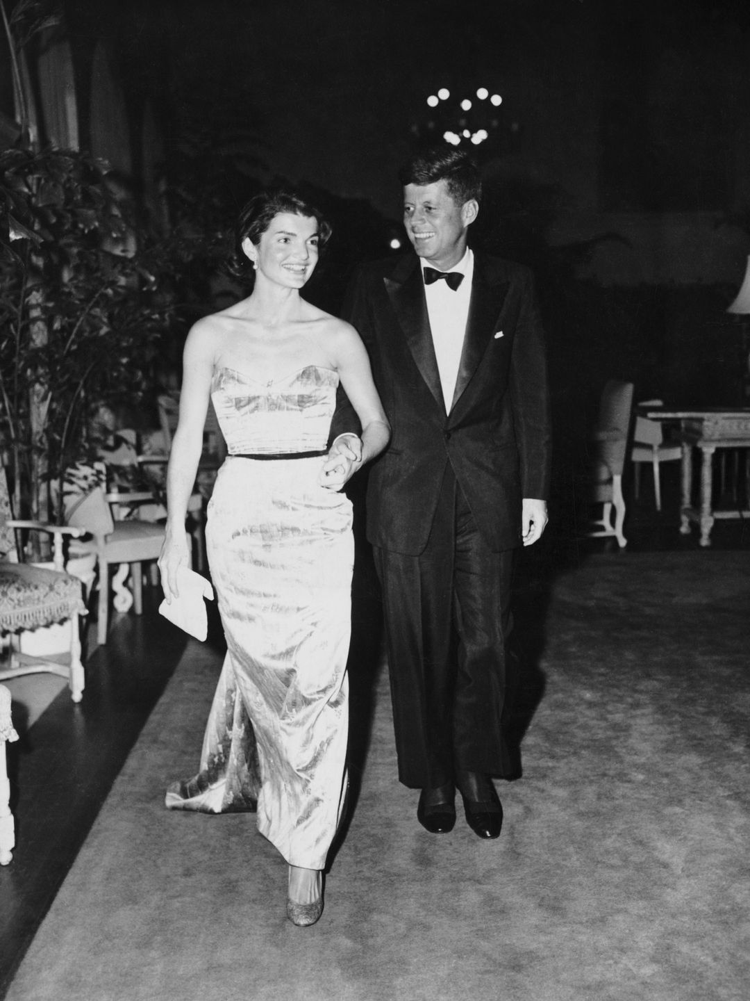 Senator John F. Kennedy walking with wife, Jackie, at the Senate Office Building.