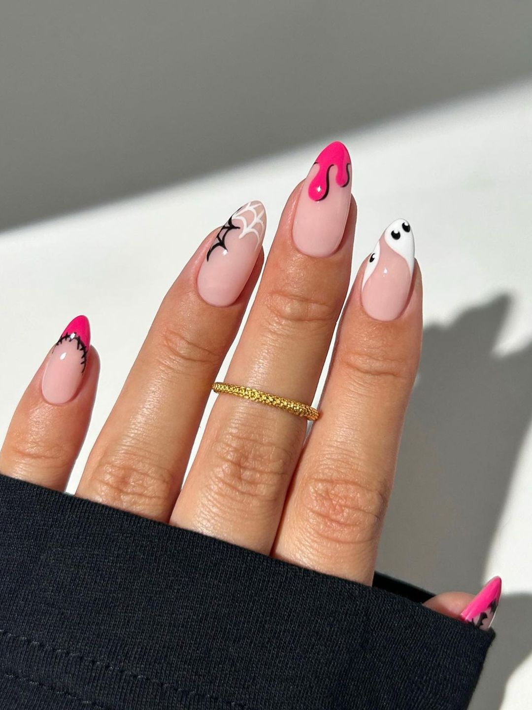 Halloween nail art with pink accents 