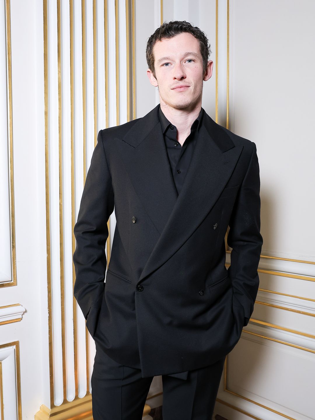 Callum Turner poses for a photo at a Tiffany & Co. event in Paris