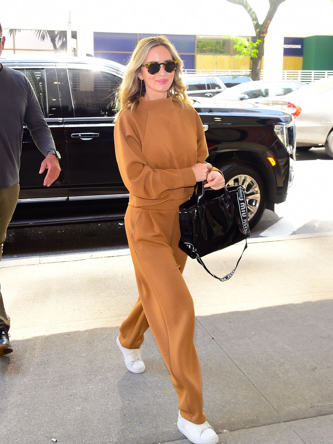 Emily Blunt is seen walking in Midtown on May 02, 2024 in New York City wearing a matching brown sweatsuit