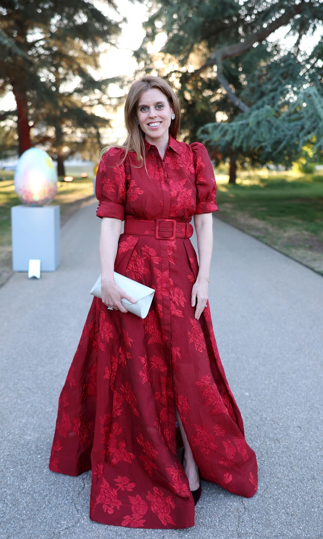 Princess Beatrice in a red dress with floral patterns