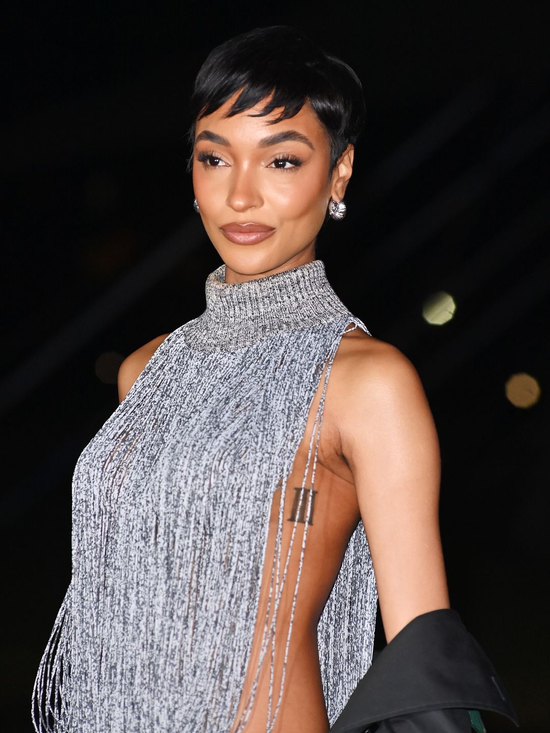 British model Jourdan Dunn stunned at the Burberry show wearing a grey turtleneck vest with open sides.