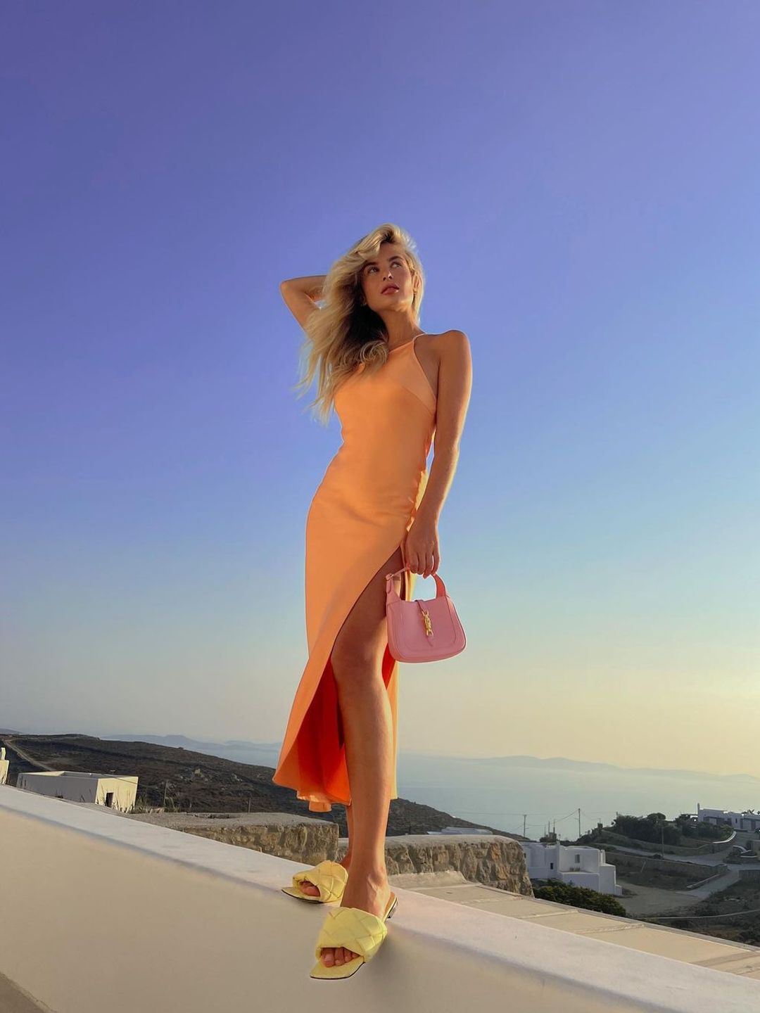 Xenia Adonts dons an orange halter neck dress 