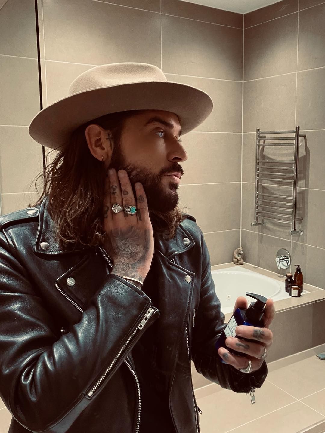 man posing in bathroom with cream product