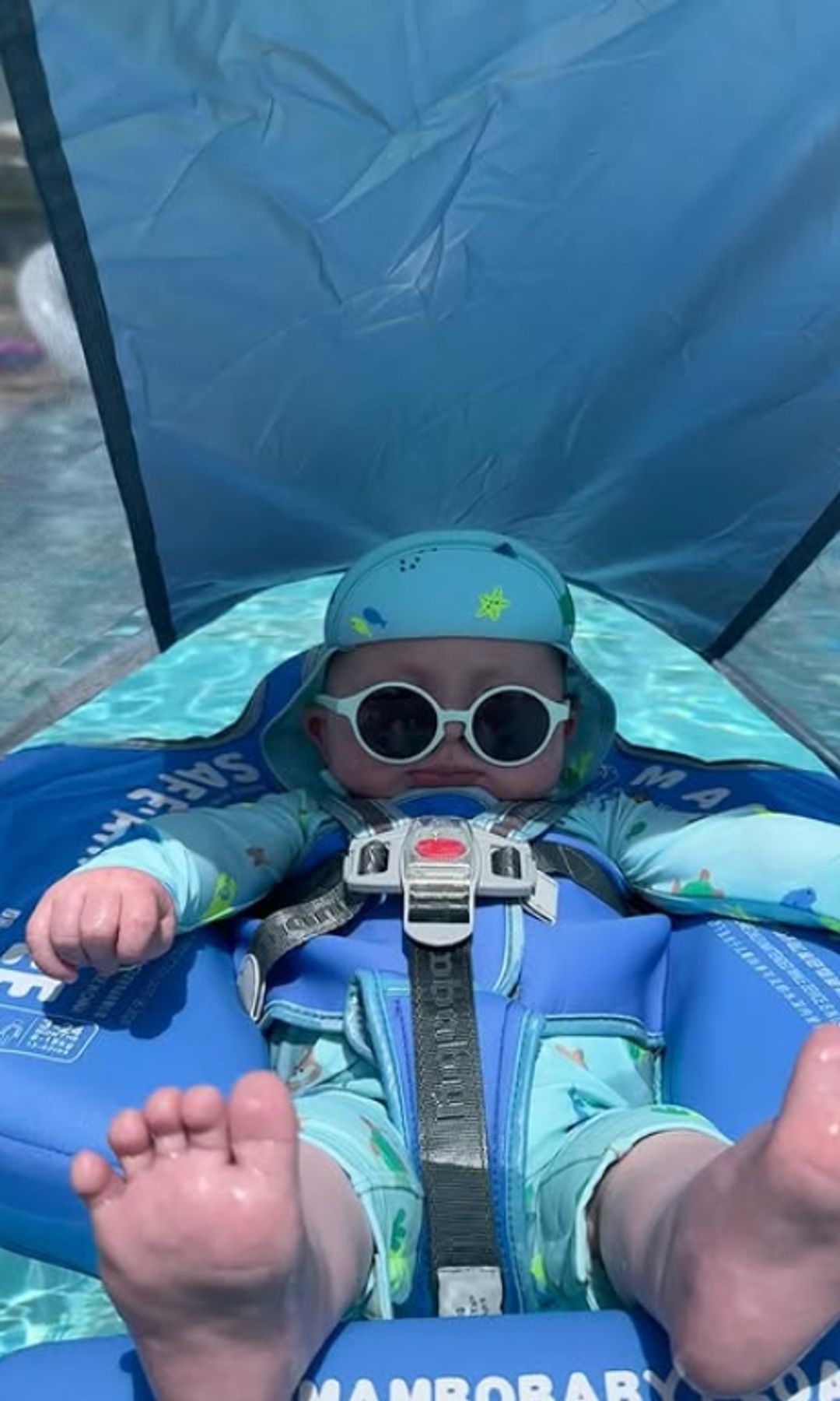 A baby floating in a pool on rubber ring