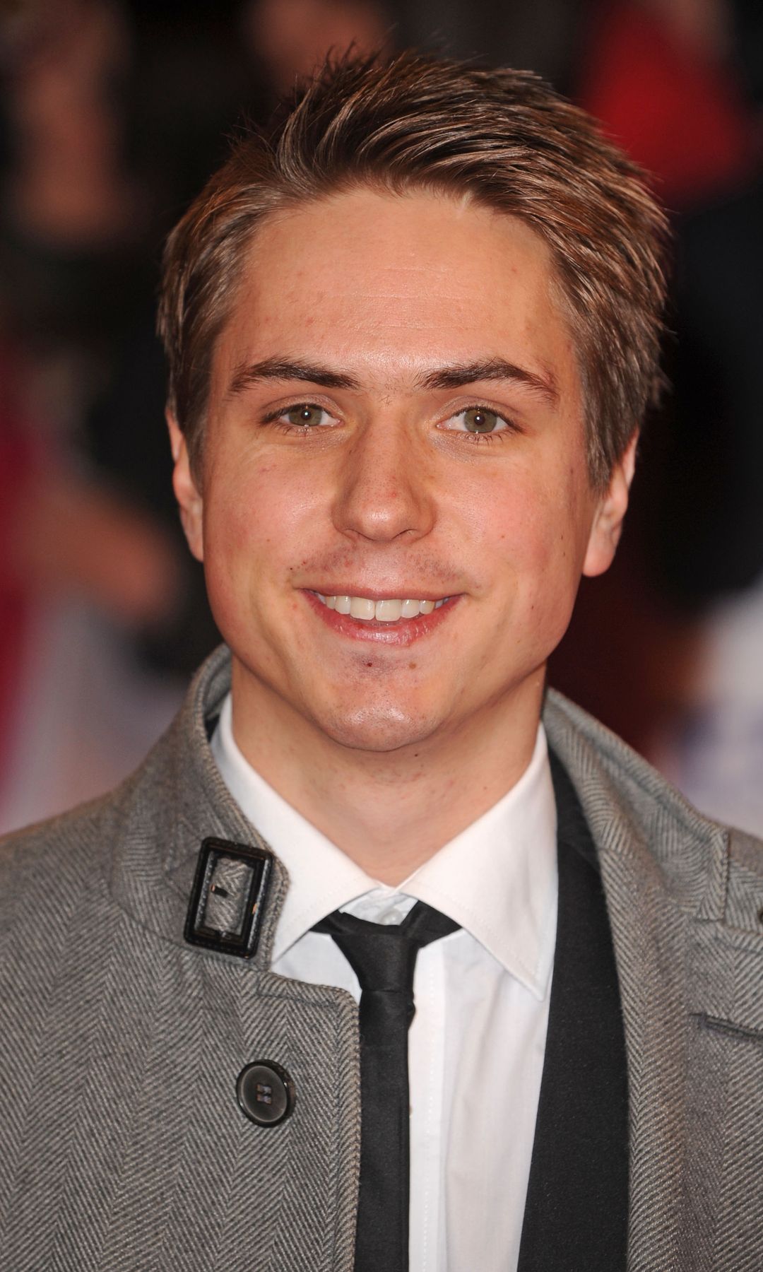 Joe Thomas in a suit and a coat