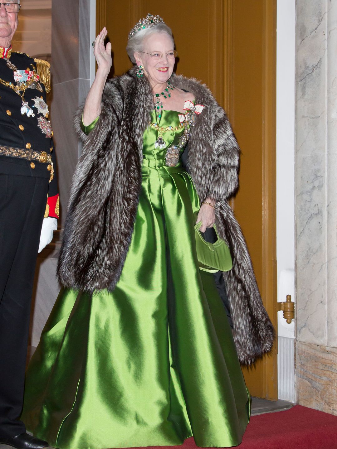 Queen Margrethe wears a mettalic green gown to attend the Traditional New Year's Banquet