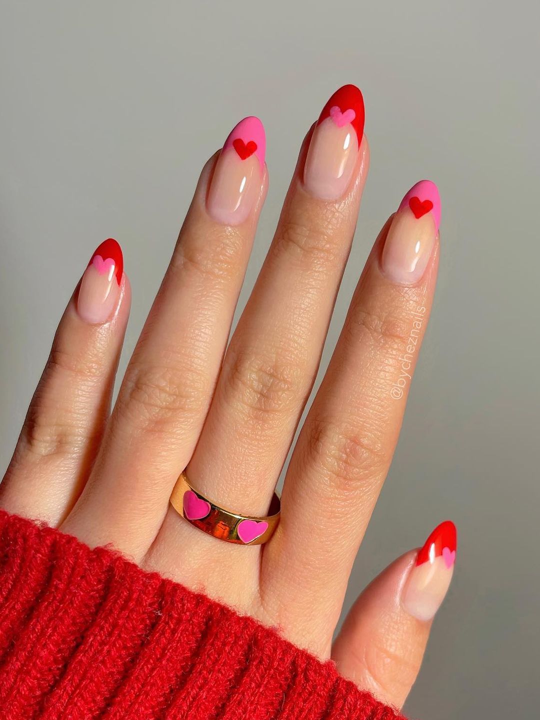 Nails with alternating red and pink hearts and tips 