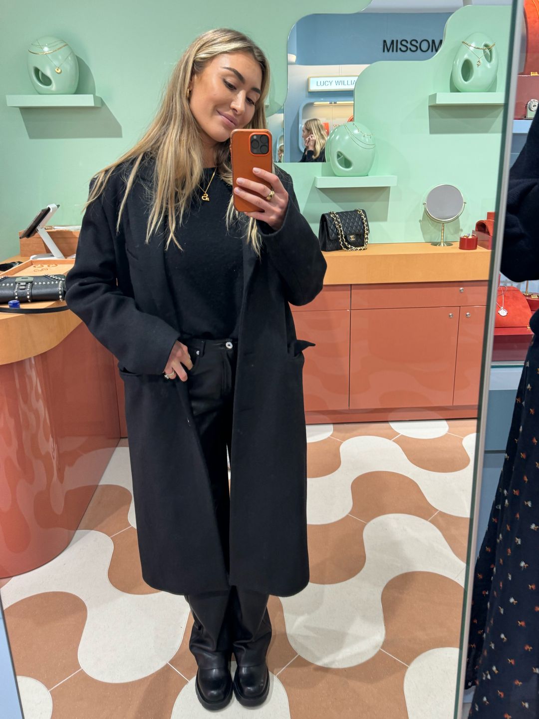 Sophie Habboo wears a black long coat from Acne, leather trousers from Mango (vegan leather), a black M&S cashmere jumper, my trusty  Zara boots and a Chanel handbag. 