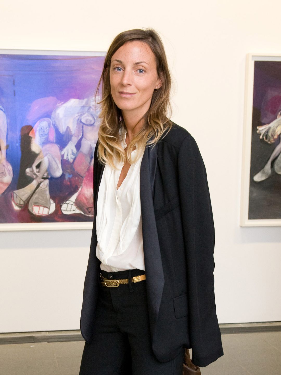 Phoebe Philo wearing a white shirt, black blazer and matching suit trousers 