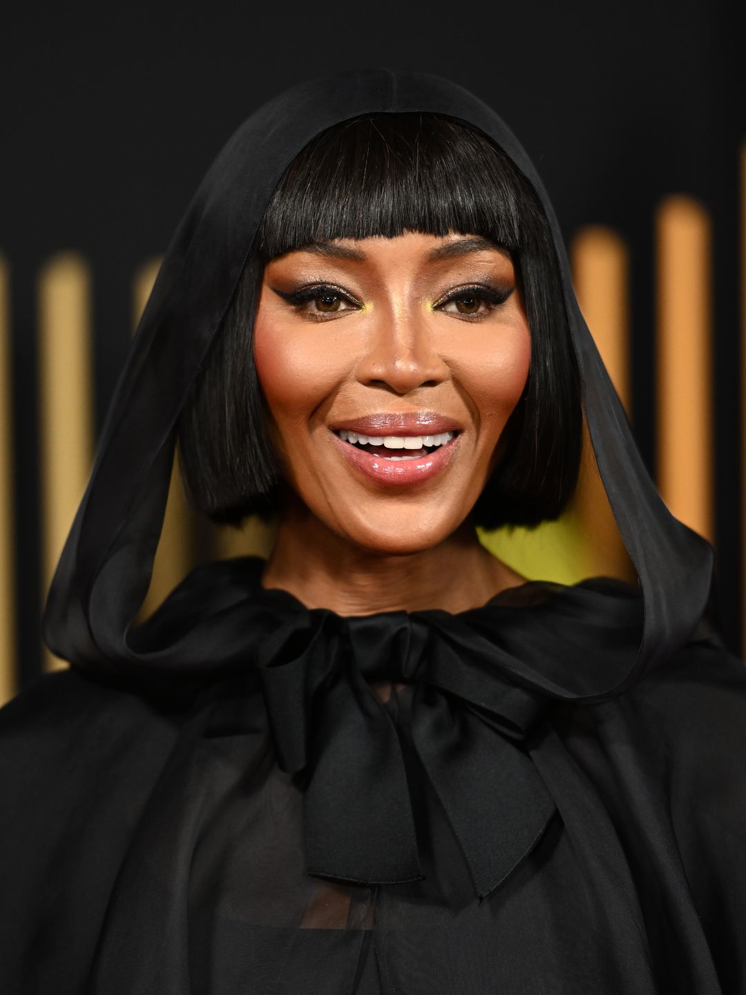 Naomi Campbell wearing a black veil and high-necked dress at the BAFTAs 