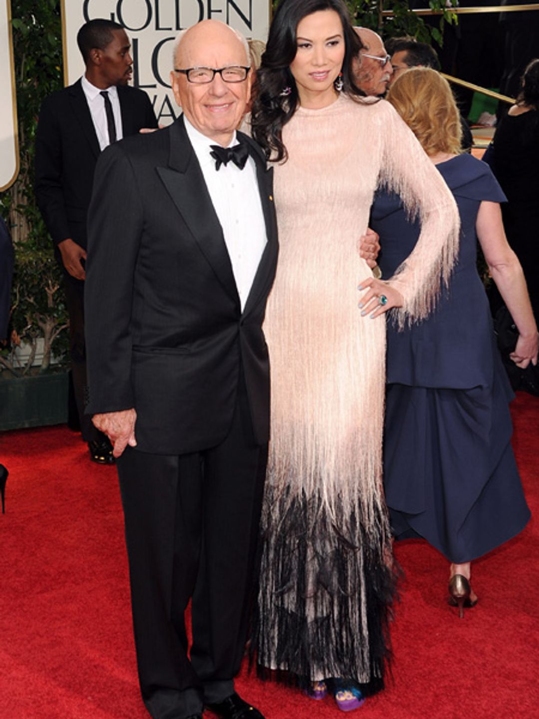Rupert Murdoch in a suit with his ex wife Wendi on the red carpet