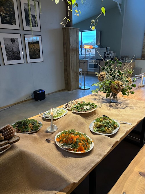 A dining room table with plates of food 