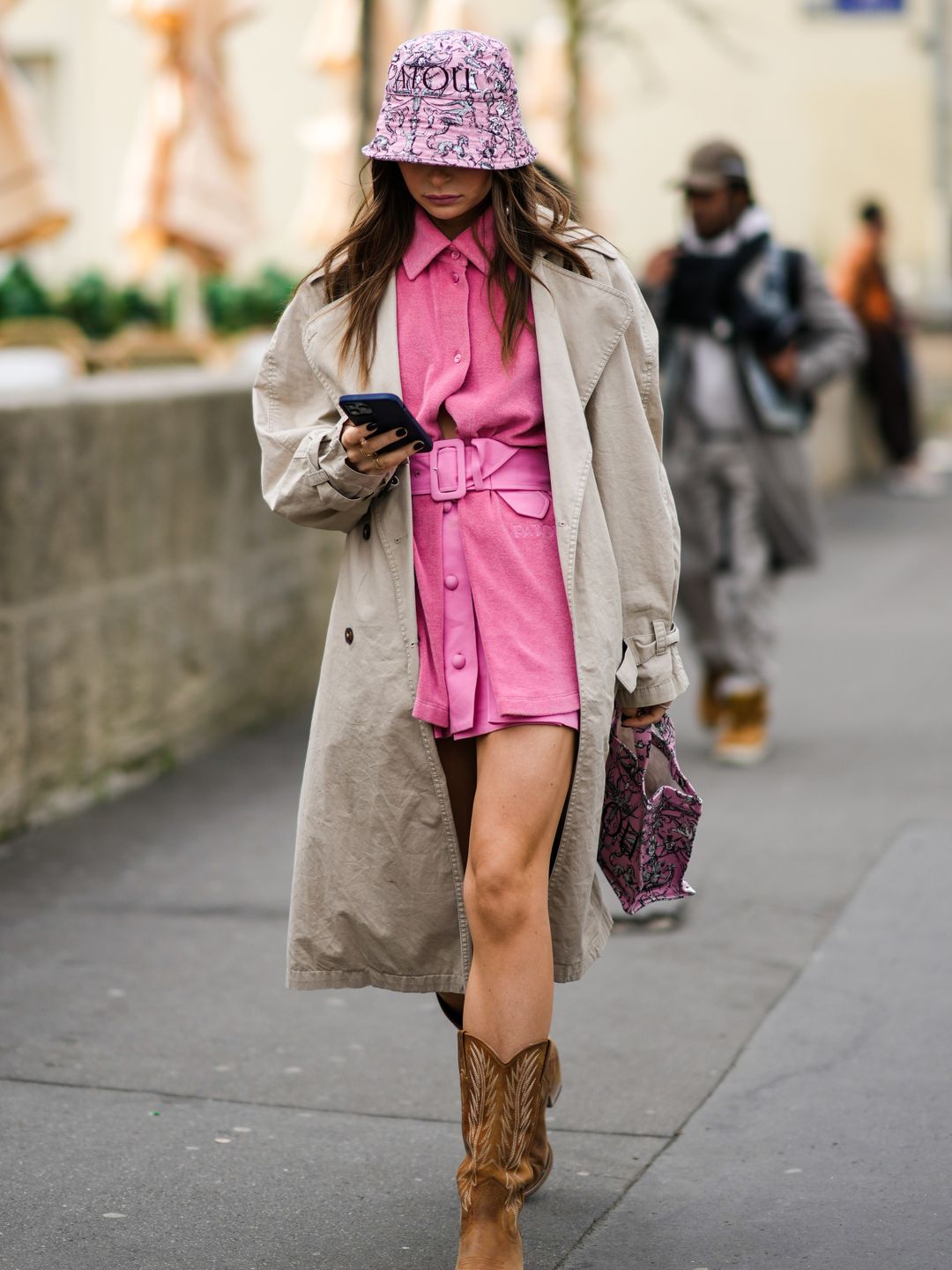 A Fashion Week teams a pink shirt dress with tan cowboy boots