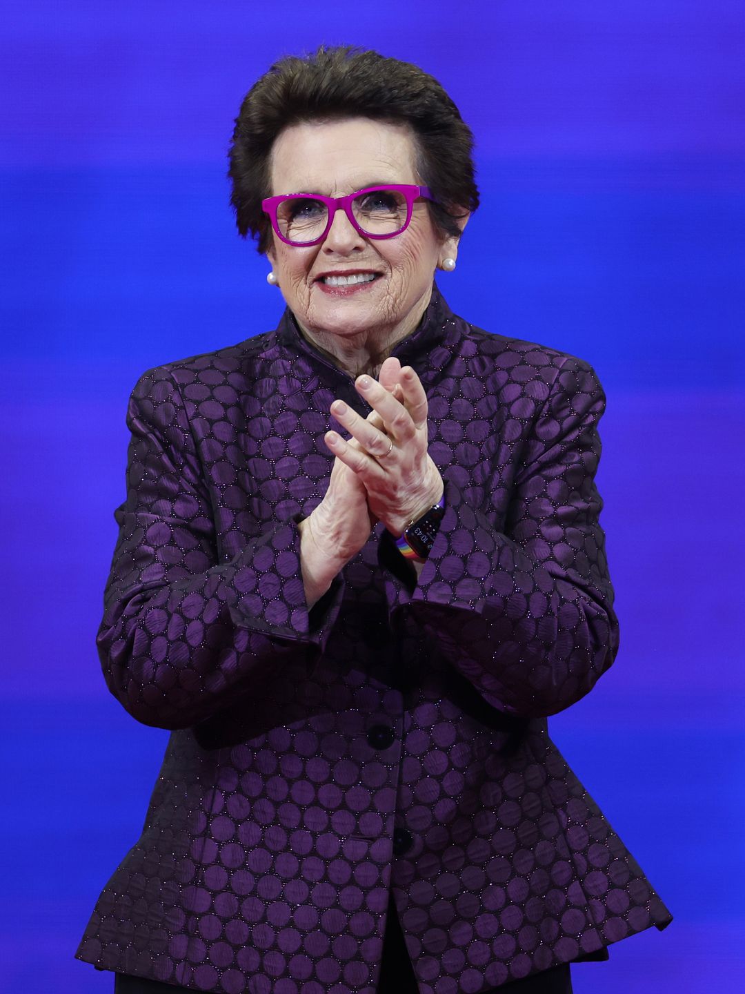 Billie Jean King in a purple jacket at the US Open 