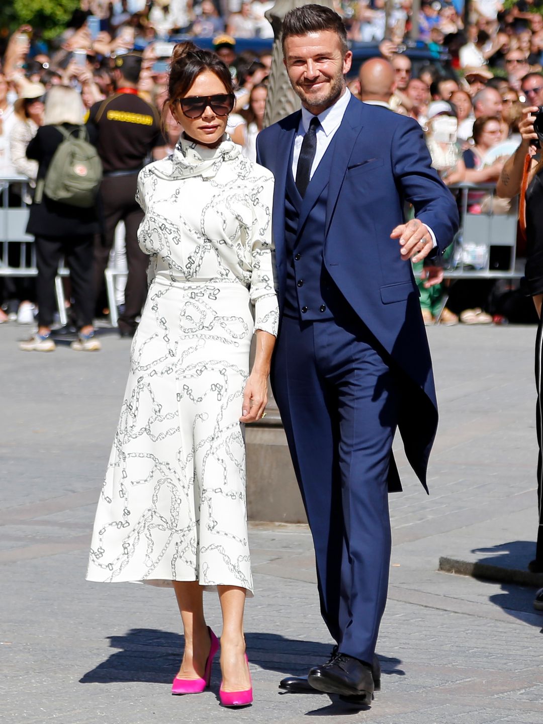David and Victoria Beckham stood outside in the sun