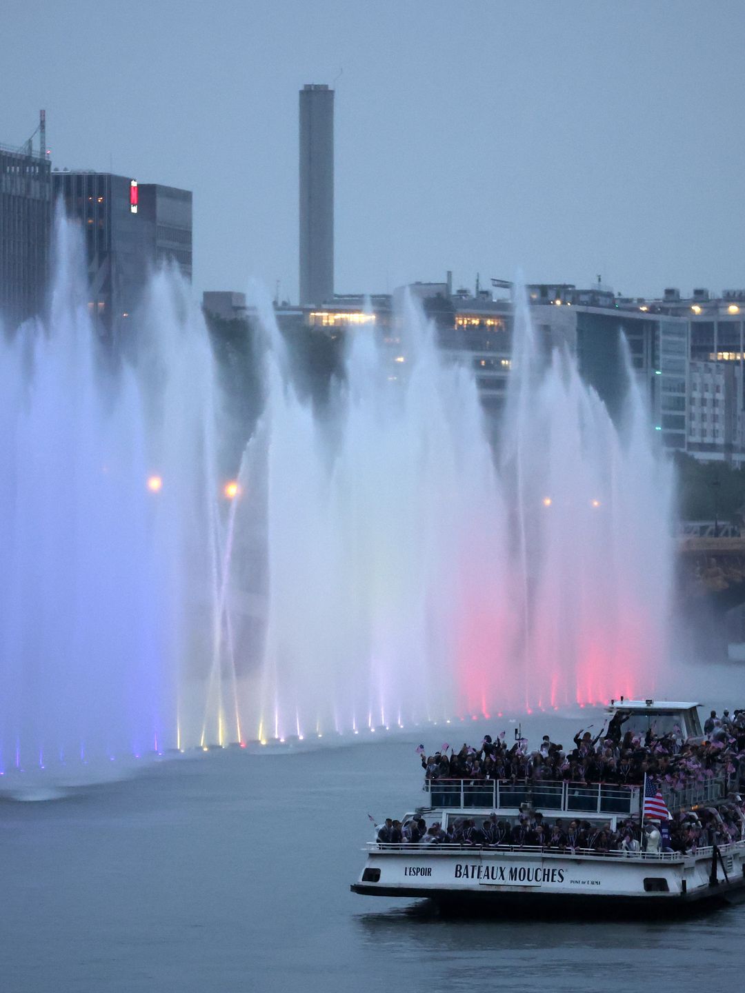 Team United States of America cruises on the River Seine during the athletes parade