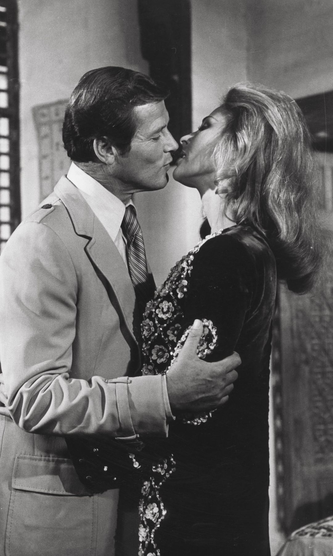 Black-and-white photo of Roger Moore and Olga Bisera kissing in The Spy Who Loved Me