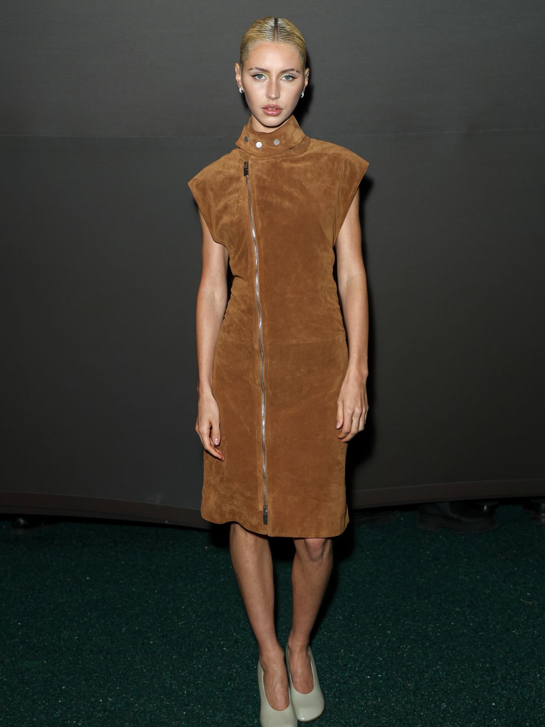 Iris Law attended the Burberry show in pure style, donning a suede brown midi dress and cream heels. 