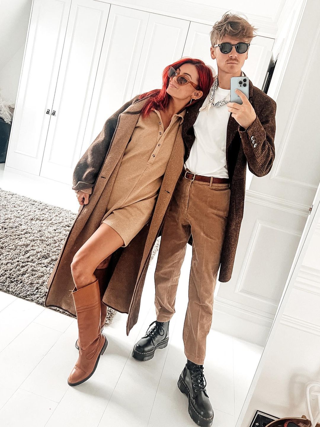 Dianne Buswell and Joe Sugg posing in front of a mirror in matching clothes