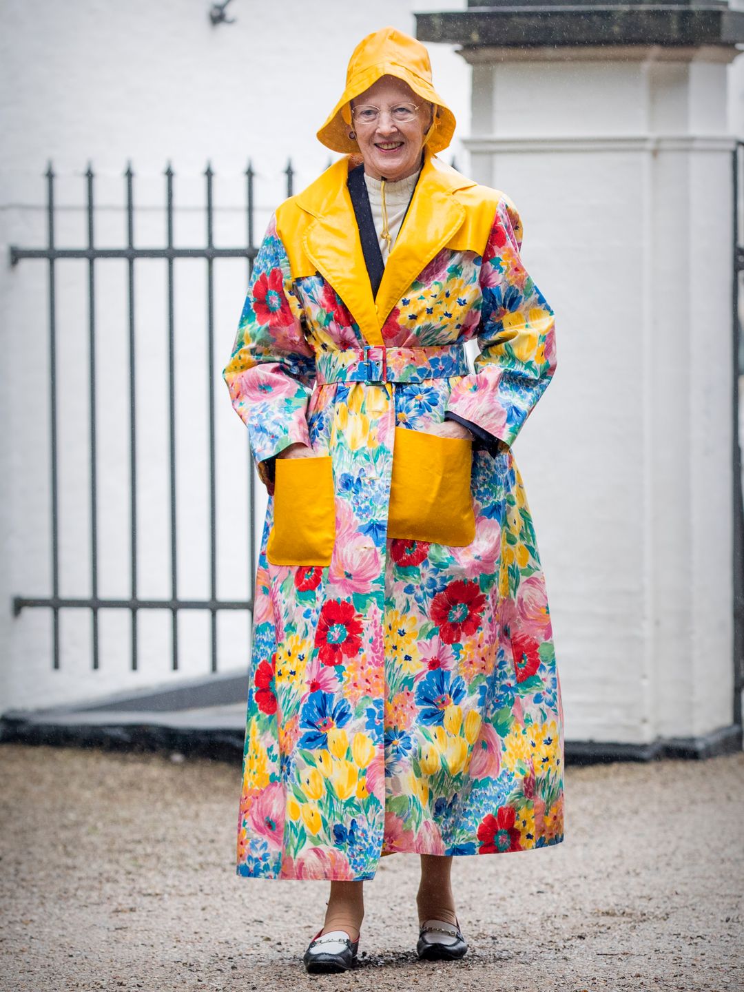 Queen Margrethe of Denmark attends the Ringsted horse ceremony in a floral rain coat and mathcing hat