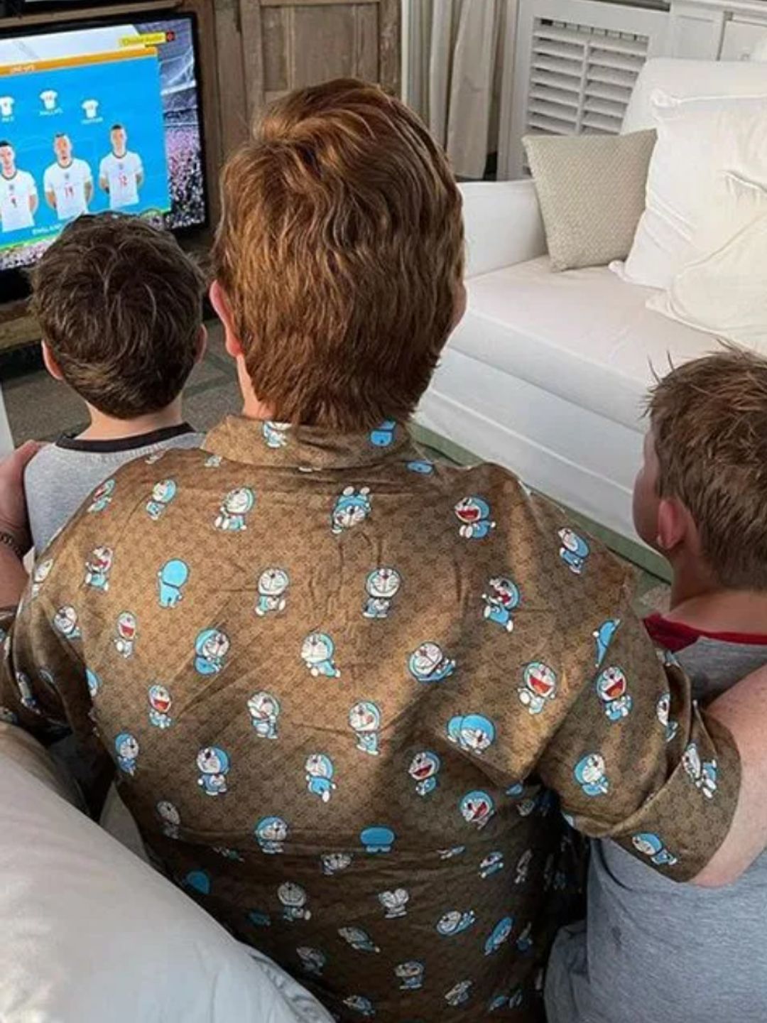Elton John and his two sons watching football
