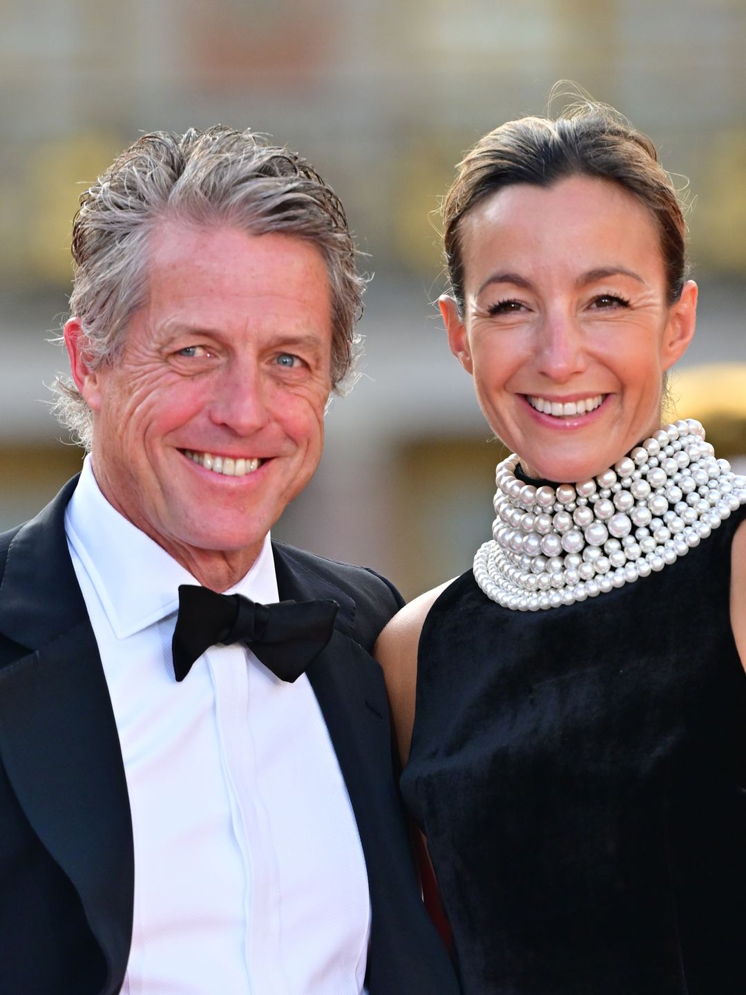 man in tuxedo and woman in black dress 