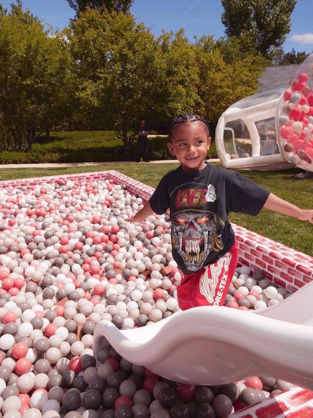 Psalm smiling in front of a red a white ball pit