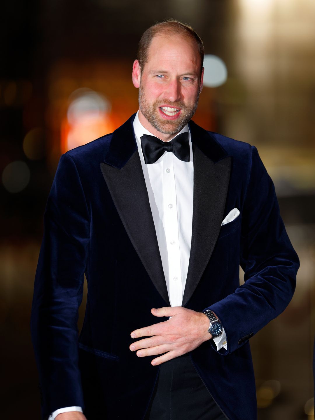 man walking in navy velvet suit 