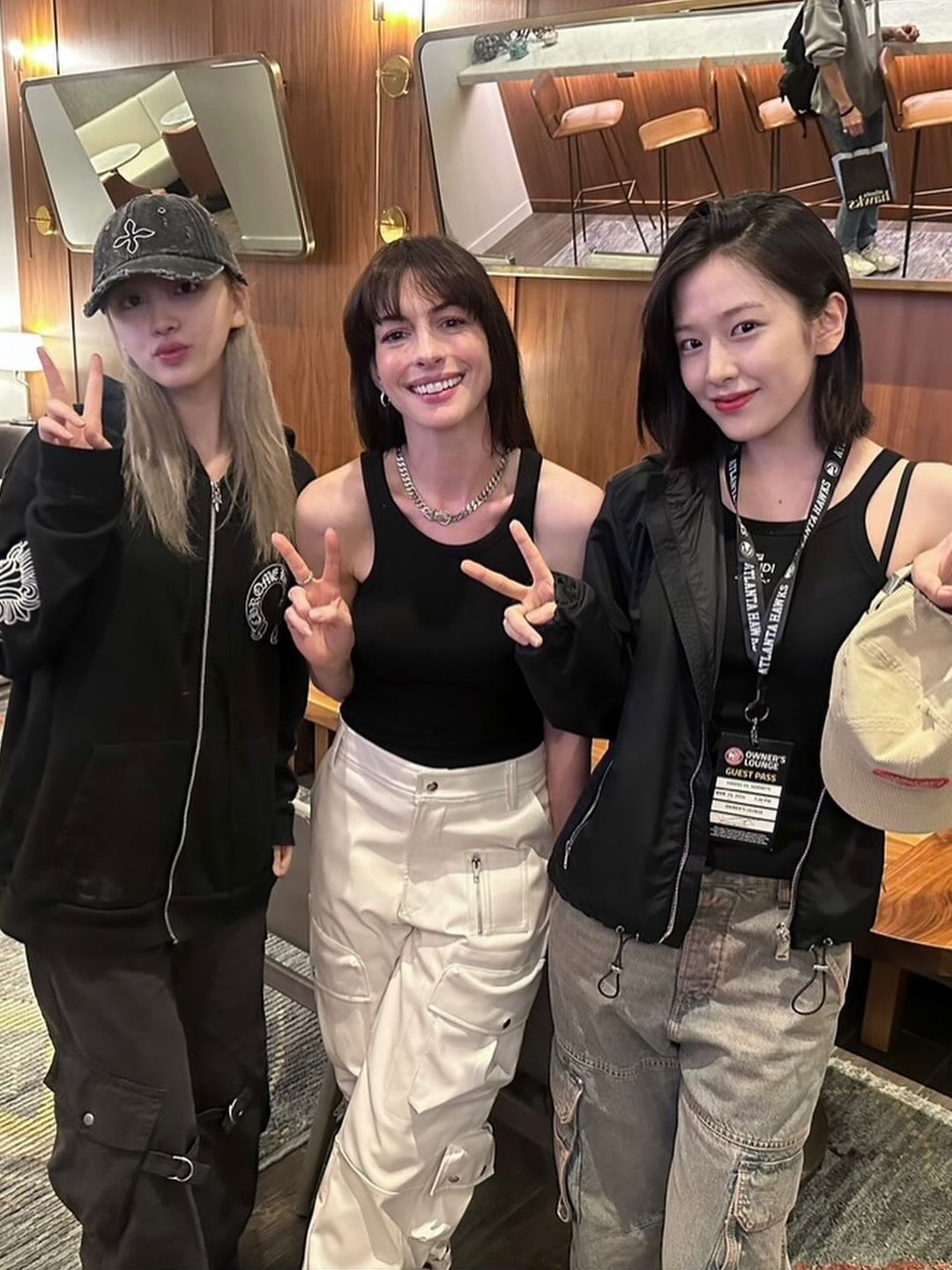 An Yujin, Anne Hathaway and LIZ pose together after a basketball game in Atlanta