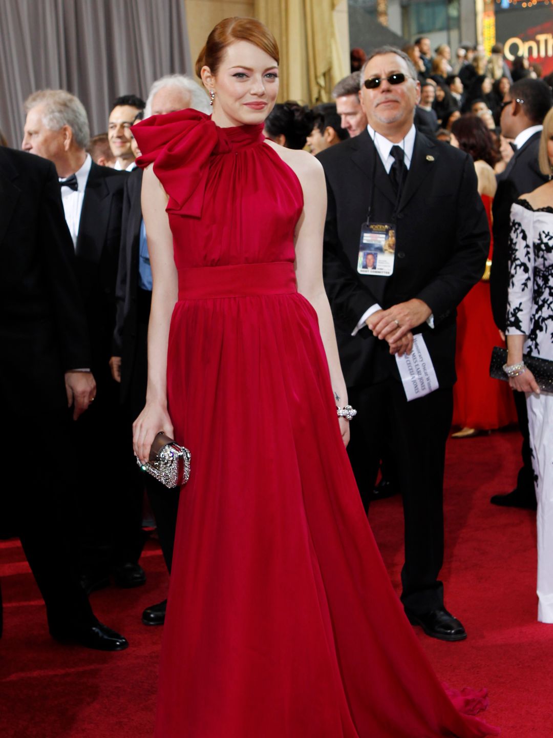  Emma Stone arrives at the 84th Annual Academy Awards in a bold red gown